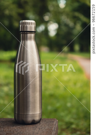 Water bottle. Reusable steel thermo water bottle on green grass. Sustainable lifestyle. Plastic free zero waste free living. Go green Environment protection Water bottle. Reusable steel thermo water bottle on green grass. Sustainable lifestyle. Plastic free zero waste free living. Go green Environment protection 96672159
