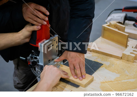 Carpenter working in carpentry workshop, designing new house furniture 96672162