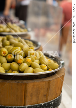 Different marinated olives and local food on street market in Gdansk, Poland. Selling and buying street food. Assortment of Appetizing olives on market Different marinated olives and local food on street market in Gdansk, Poland. Selling and buying street food. Assortment of Appetizing olives on market 96672217