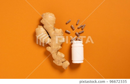Fresh ginger root jar with vitamin pills orange background, medicine, nutritional supplements Fresh ginger root jar with vitamin pills orange background, medicine, nutritional supplements 96672335