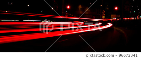 Lights of cars at night. Street line lights. Night highway city. Long exposure photograph night road. Colored bands of red light trails on the road. Background wallpaper defocused blurred Banner size 96672341