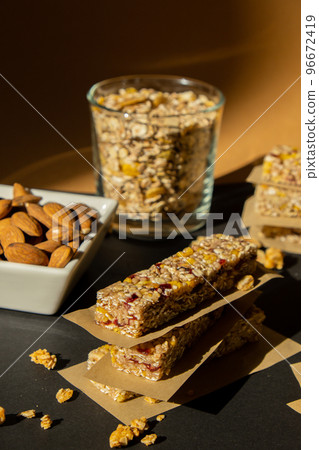 Homemade Granola energy bar. Variety of homemade protein granola breakfast bars ingredients nuts, raisins dried cherries and chocolate. Healthy nutrition eating Gluten free cereal dieting snack super Homemade Granola energy bar. Variety of homemade protein granola breakfast bars ingredients nuts, raisins dried cherries and chocolate. Healthy nutrition eating Gluten free cereal dieting snack super 96672419