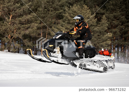 In deep powder snowdrift snowmobile rider driving fast. In deep powder snowdrift snowmobile rider driving fast. 96673282