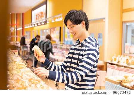 Man shopping at supermarket bakery Man shopping at supermarket bakery 96673472