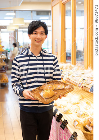 Man shopping at supermarket bakery Man shopping at supermarket bakery 96673473