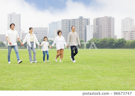 Three generation family walking hand in hand 96673747