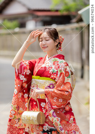 A woman in a kimono standing in the back alley 96674034