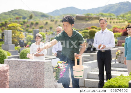 man washing a grave 96674402