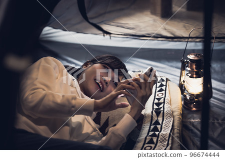 House camp A woman using a smartphone 96674444