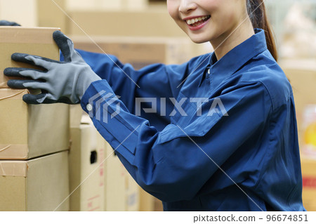 Female worker working in a warehouse Female worker working in a warehouse 96674851
