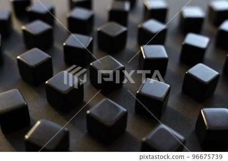 Black blocks on a dark background. Scattered cubes. Abstraction, field blur. Simplicity and elegance. Solidity, shine. Black blocks on a dark background. Scattered cubes. Abstraction, field blur. Simplicity and elegance. Solidity, shine. 96675739