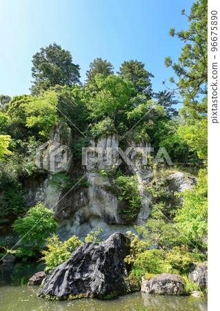 A scene of a sacred giant rock decorated with shimenawa looking up at the blue sky background @ Ishikawa A scene of a sacred giant rock decorated with shimenawa looking up at the blue sky background @ Ishikawa 96675890