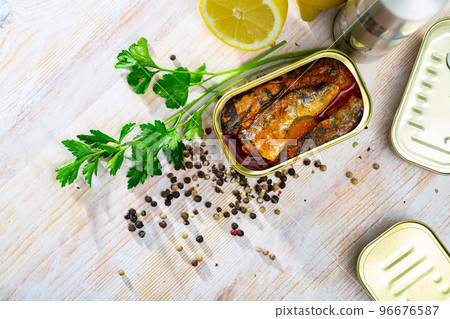 Tin can with smoked sprats, sardines, closeup 96676587