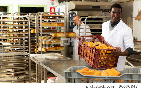 Portrait of successful baker during daily work in bakeshop Portrait of successful baker during daily work in bakeshop 96676848