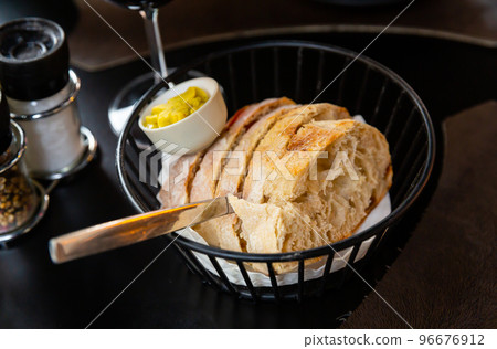 Slices of bread with butter 96676912