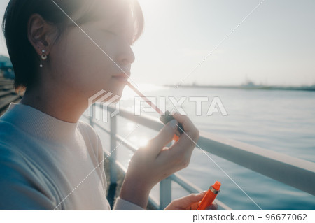 一位年輕女子應用光澤的照片 一位年輕女子應用光澤的照片 96677062