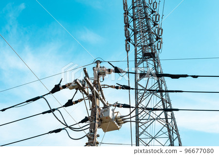 Power transmission tower that supports high-voltage power lines and wires in a residential area a-4 light tone Power transmission tower that supports high-voltage power lines and wires in a residential area a-4 light tone 96677080
