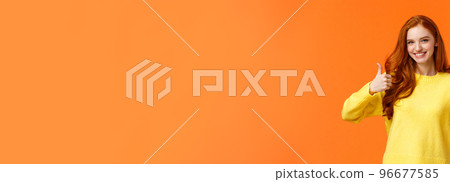 Confident and caring good-looking redhead sister rooting for sibling, saying yes, approving choice, recommend product, show thumbs-up and nod acceptance, smiling positive reply, orange wall Confident and caring good-looking redhead sister rooting for sibling, saying yes, approving choice, recommend product, show thumbs-up and nod acceptance, smiling positive reply, orange wall 96677585