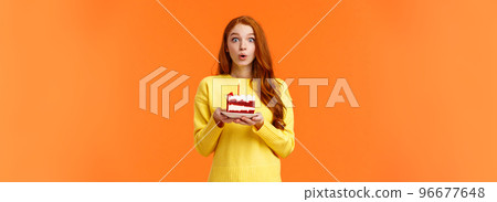 Carefree dreamy cute redhead girl making wish, quickly make-up desire to blow out candle on birthday cake, folding lips holding breath, want dream come true, look camera overwhelmed, b-day concept Carefree dreamy cute redhead girl making wish, quickly make-up desire to blow out candle on birthday cake, folding lips holding breath, want dream come true, look camera overwhelmed, b-day concept 96677648
