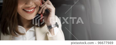 Close-up happy woman talking on the mobile phone while traveling by car. 96677989