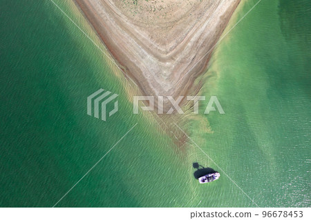 Aerial view of island surrounded by sea or ocean, the boat floats in the water. Colorful landscape with beautiful nature. Tourism, traveling. 96678453