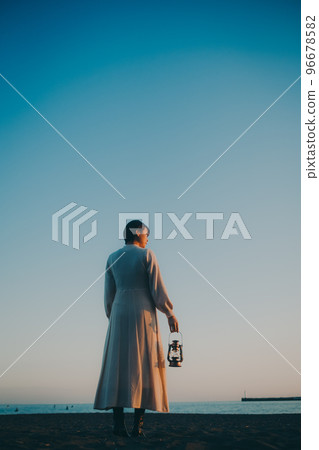 Photo of a young woman with a lantern Photo of a young woman with a lantern 96678582