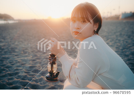 Photo of a young woman with a lantern 96678595