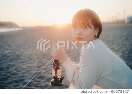 Photo of a young woman with a lantern Photo of a young woman with a lantern 96678597