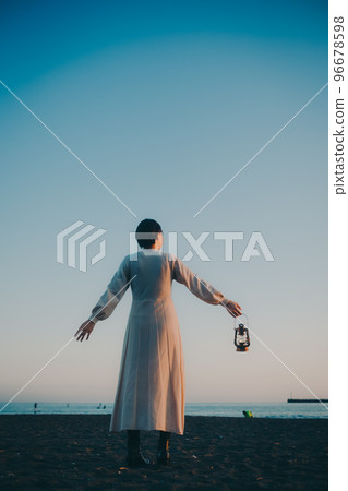 Photo of a young woman with a lantern Photo of a young woman with a lantern 96678598