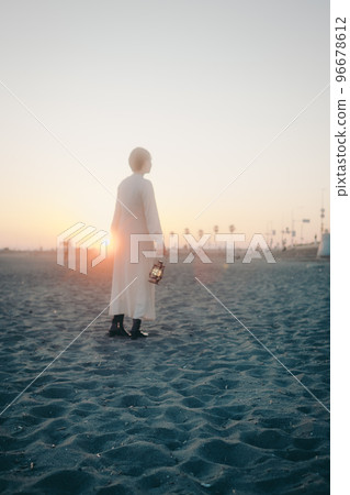Photo of a young woman with a lantern Photo of a young woman with a lantern 96678612