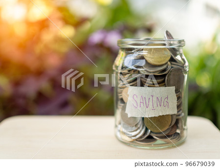 Coins in glass bottles on nature background. The concept of savings and investment. 96679039