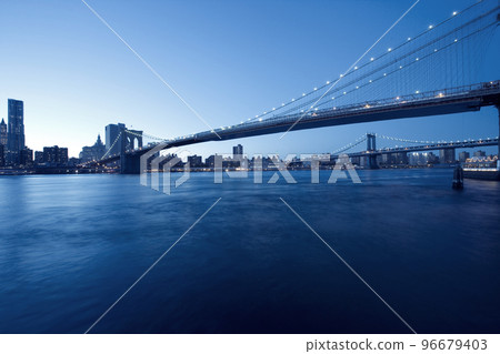 Brooklyn Bridge by night with skyscrapers, New York panoramic view of Manhattan skyline 96679403