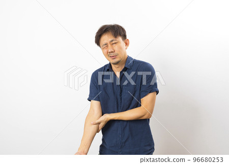 Asian man with pain in elbow against white background. People suffering from chronic joint rheumatism. 96680253