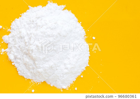 Baking soda on yellow background. Baking soda on yellow background. 96680361