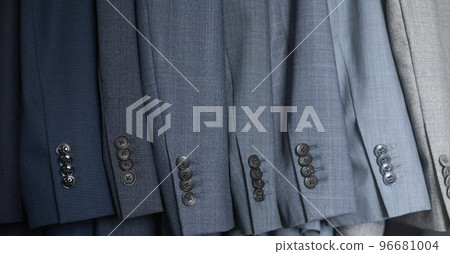 Male blazer coat and necktie neatly hanging at cupboard comfortable storage organization closeup 96681004
