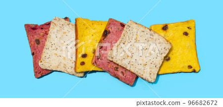 Whole grain bread slices on blue background. 96682672
