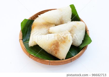 Grilled sticky rice in banana leave with mung beans filling Grilled sticky rice in banana leave with mung beans filling 96682713
