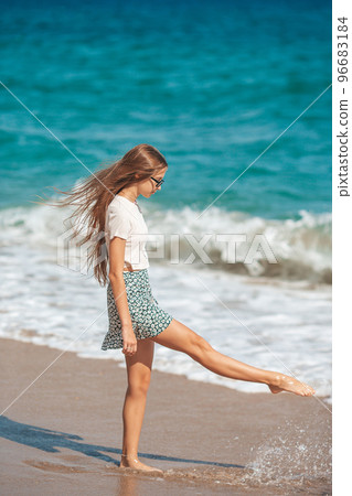 Adorable teen girl have fun at tropical beach during vacation at shallow water Adorable teen girl have fun at tropical beach during vacation at shallow water 96683184