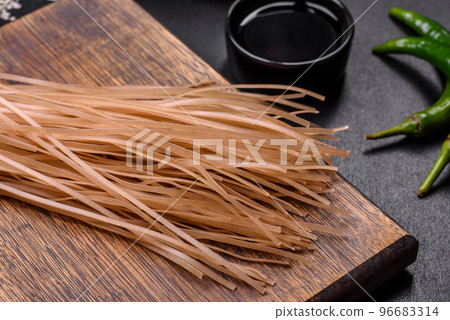 Tasty dish of Asian cuisine with rice noodles, chicken, asparagus, pepper, sesame seeds and soy sauce Tasty dish of Asian cuisine with rice noodles, chicken, asparagus, pepper, sesame seeds and soy sauce 96683314