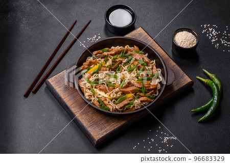 Tasty dish of Asian cuisine with rice noodles, chicken, asparagus, pepper, sesame seeds and soy sauce Tasty dish of Asian cuisine with rice noodles, chicken, asparagus, pepper, sesame seeds and soy sauce 96683329