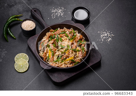Tasty dish of Asian cuisine with rice noodles, chicken, asparagus, pepper, sesame seeds and soy sauce Tasty dish of Asian cuisine with rice noodles, chicken, asparagus, pepper, sesame seeds and soy sauce 96683343
