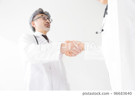 people in white coats shaking hands people in white coats shaking hands 96683640