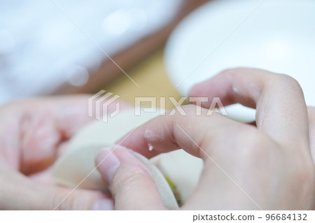 Making dumplings with translucent skin-colored fingers Making dumplings with translucent skin-colored fingers 96684132