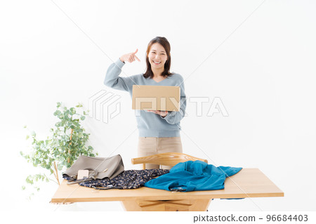 A woman with a cardboard box 96684403