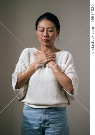 Japanese middle-aged woman with chest pain Japanese middle-aged woman with chest pain 96684820