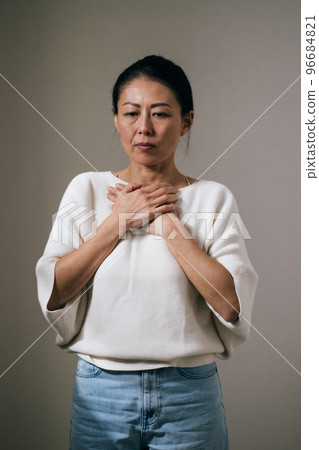 Japanese middle-aged woman with chest pain Japanese middle-aged woman with chest pain 96684821