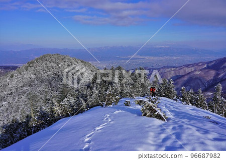 冬季從常念山東脊眺望安曇野市景的登山者 冬季從常念山東脊眺望安曇野市景的登山者 96687982
