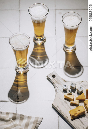 Beer and cheese. Glass of beer with cheese. Ale and food concept 96688996