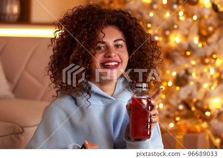 woman eating sushi, asian food restaurant, romantic evening, eating sushi with chopsticks, sushi delivery and takeout, eating at home, romantic dinner alone in christmas decor. Eve New year, saving woman eating sushi, asian food restaurant, romantic evening, eating sushi with chopsticks, sushi delivery and takeout, eating at home, romantic dinner alone in christmas decor. Eve New year, saving 96689033