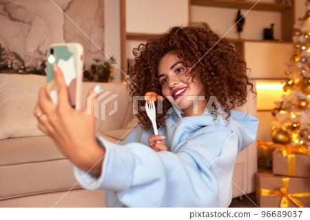 woman eating sushi, asian food restaurant, romantic evening, eating sushi with chopsticks, sushi delivery and takeout, eating at home, romantic dinner alone in christmas decor. Eve New year, saving woman eating sushi, asian food restaurant, romantic evening, eating sushi with chopsticks, sushi delivery and takeout, eating at home, romantic dinner alone in christmas decor. Eve New year, saving 96689037